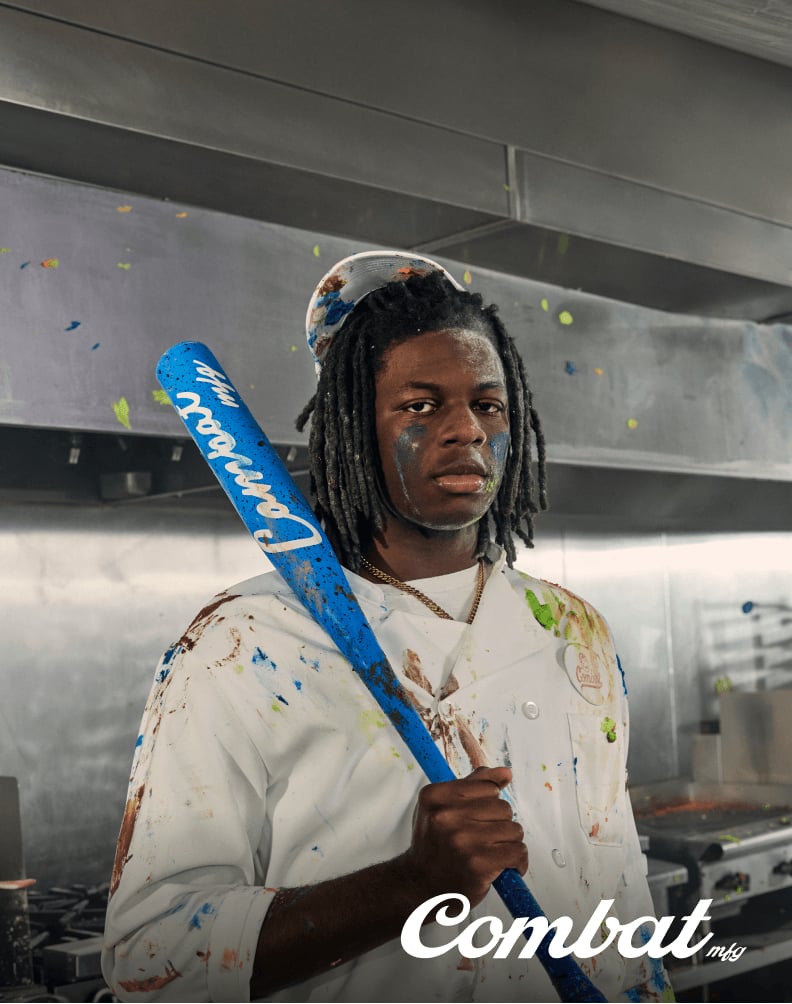 Combat baseball bat in the Cookie Jar design held upright in an indoor studio setting.