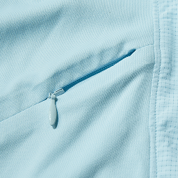 Close-up of a Jacob Wheeler Magellan Outdoor Pro Ventilated Hoodie showing a small zip pocket with a matching blue zipper pull.