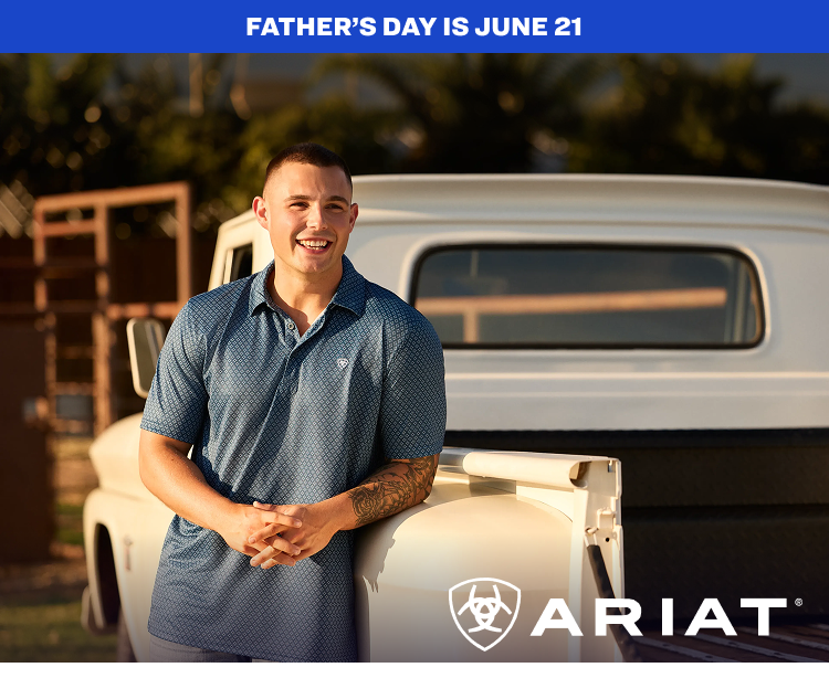 Person wearing a short-sleeve polo shirt standing outdoors near a vehicle.