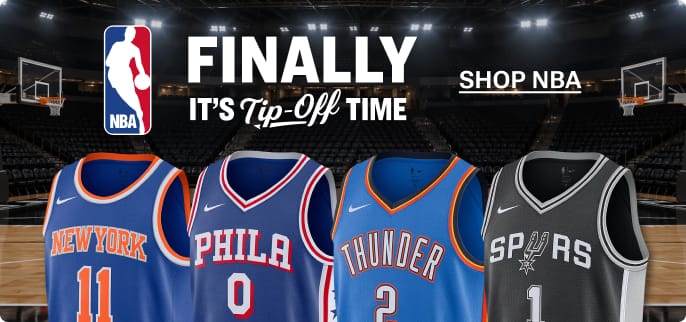 NBA logo and Philadelphia, Oklahoma City, New York, and San Antonio basketball jerseys displayed courtside inside an arena with the text 'Finally It's Tip-Off Time' and a Shop NBA button.