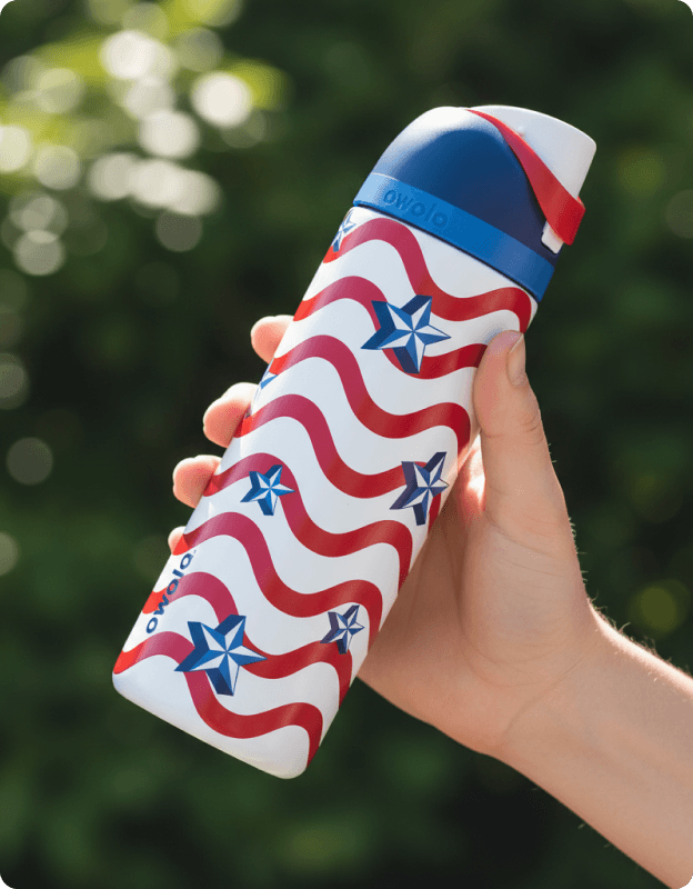 Owala FreeSip stainless steel water bottle with wavy red, white, and blue flag pattern.