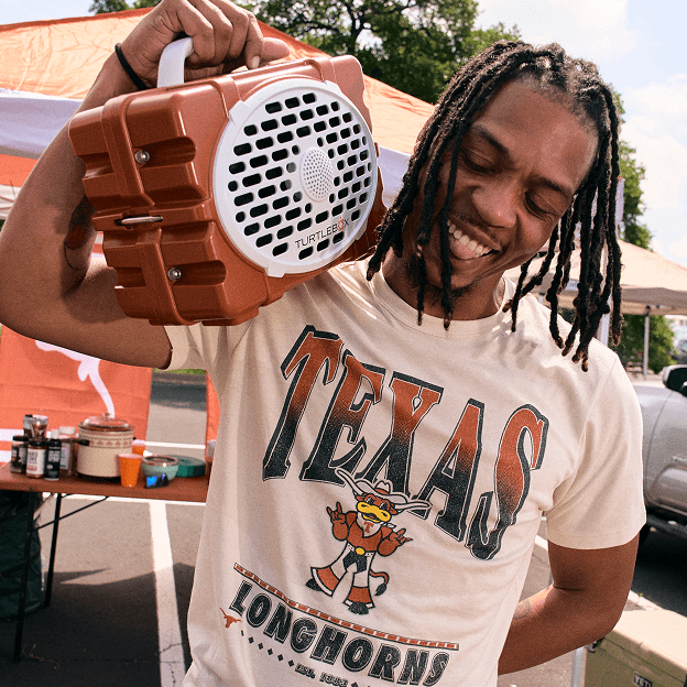 Portable Texas Longhorns speaker carried at an outdoor tailgate gathering.