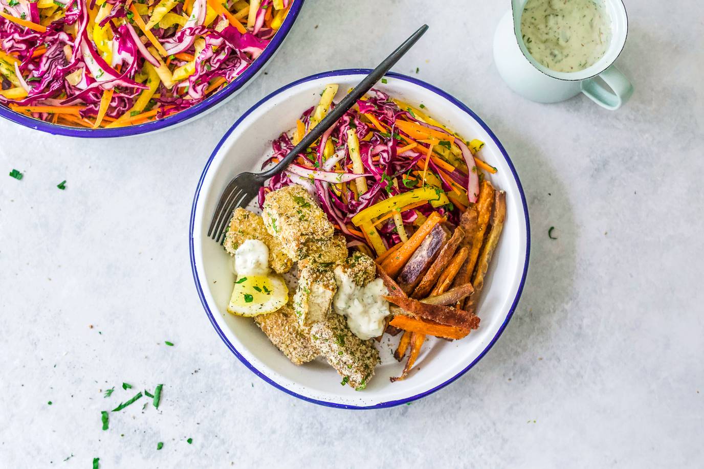 Herb crusted tofu with crispy kumara chips and rainbow slaw