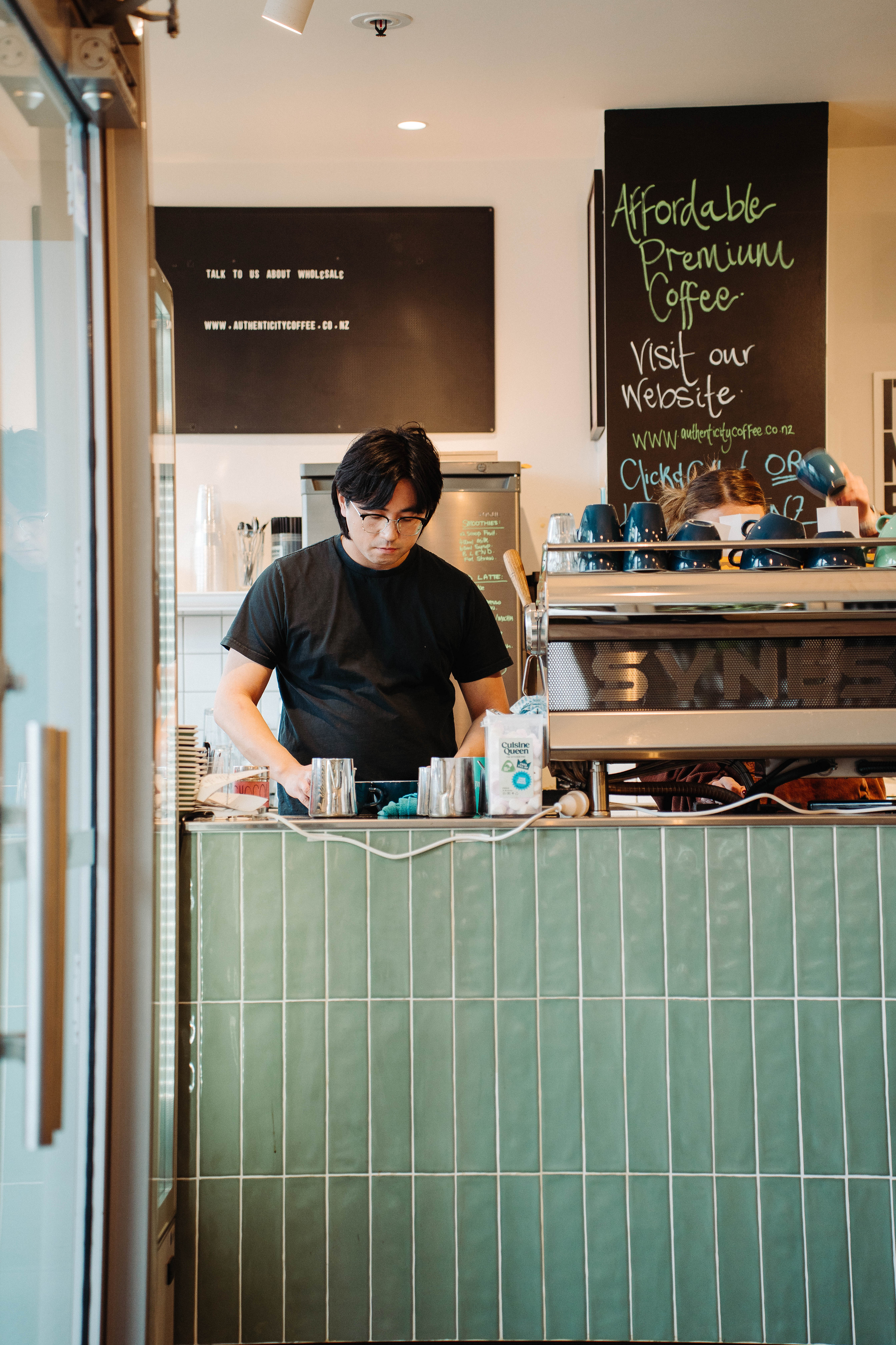 Photograph of the Authenticity Cafe in Christchurch, New Zealand, likely showing the café interior or ambiance. JPEG image suitable for use as a lifestyle/location visual asset.