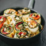 https://images.contentstack.io/v3/assets/blt9777ffe07a3470fa/bltc6437c7804545008/6738773d185da5483cefae62/Pesto-Zucchini-Roll-Up-Lasagna_domcherry-2473-(1).png