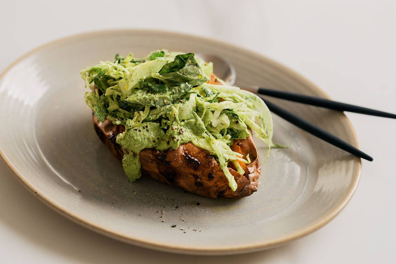 Super green loaded baked potatoes with a creamy green tahini dressing