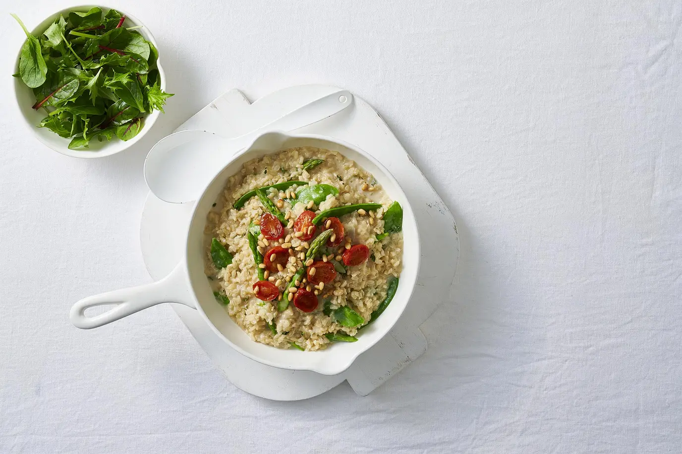 Brown rice risotto with cherry tomatoes, asparagus and snow peas