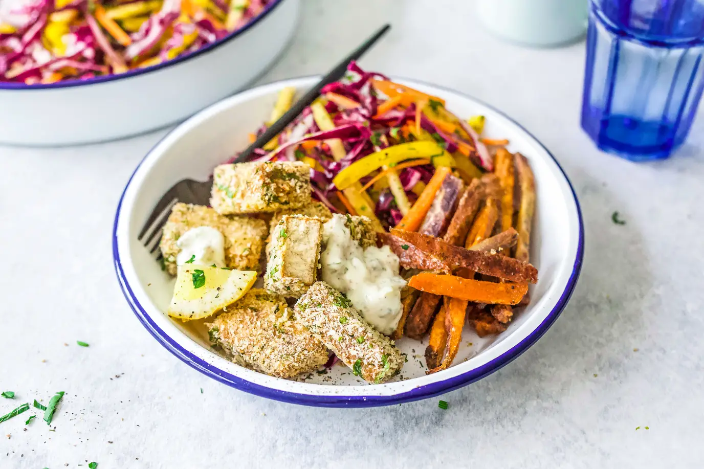 Herb crusted tofu with crispy kumara chips and rainbow slaw