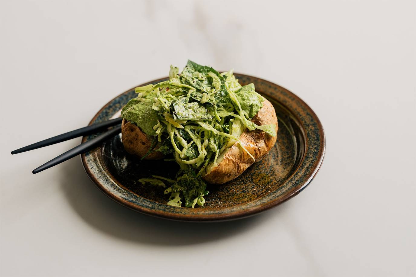 Super green loaded baked potatoes with a creamy green tahini dressing