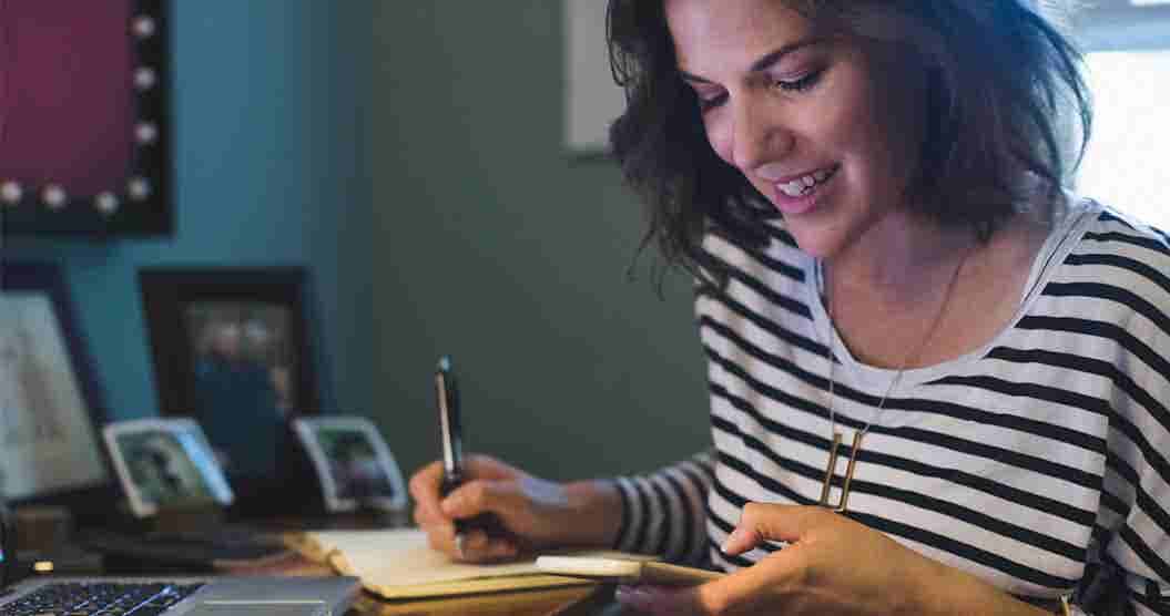 Woman taking notes on how to borrow money fast