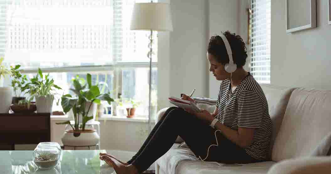 Young woman taking notes while listening to financial advice