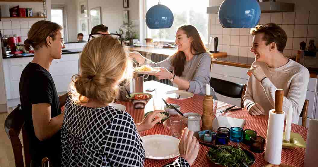 Family at table discussing Money Savings Challenges