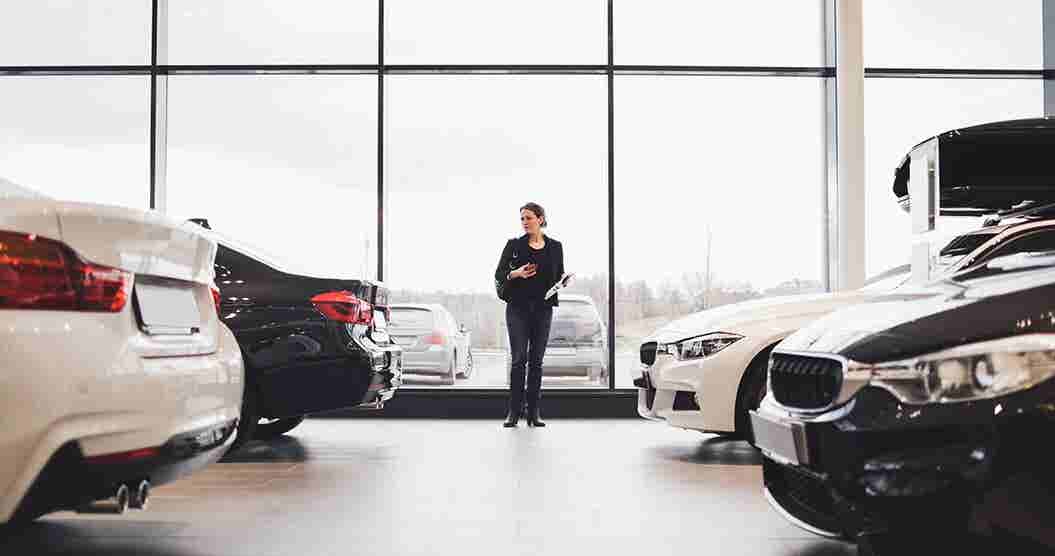 Woman  shopping for a car to lease at a dealership.