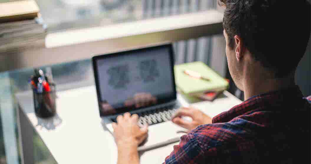 Man researching good debt on his laptop