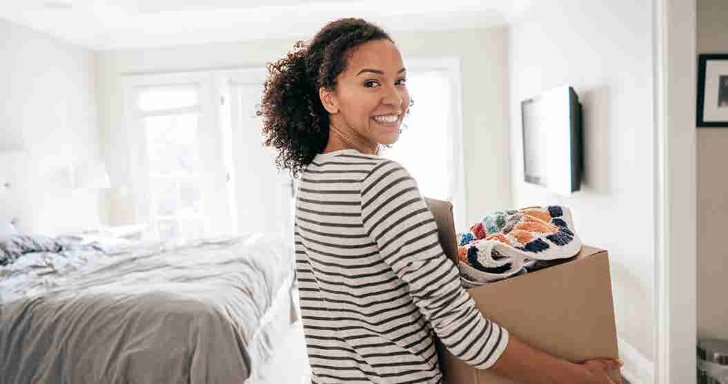 Woman carry a box and organizing her home.