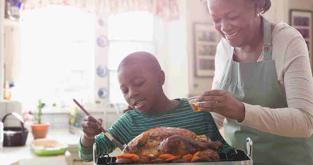Grandmother helping grandson prepare a Thanksgiving meal on a budget