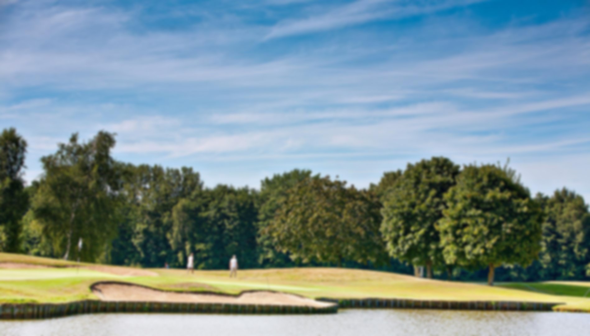 The 1st green which is surrounded by the lake