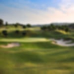 Blissful blue skies over wide greens and large bunkers