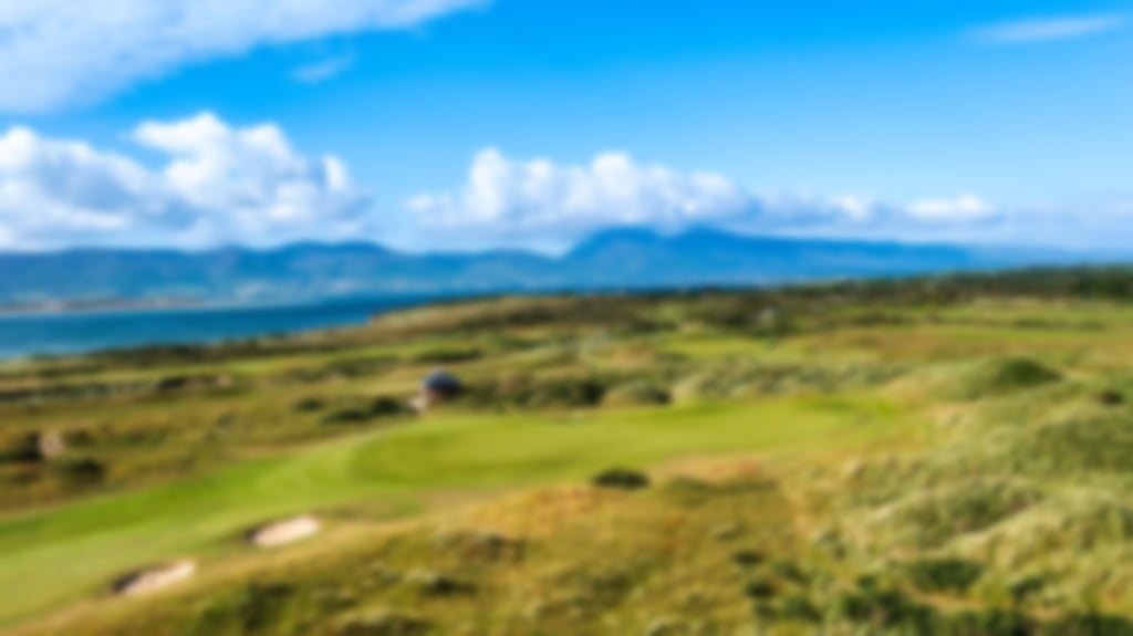 Scenic view of Dooks Golf Club with undulating fairways and distant mountains.