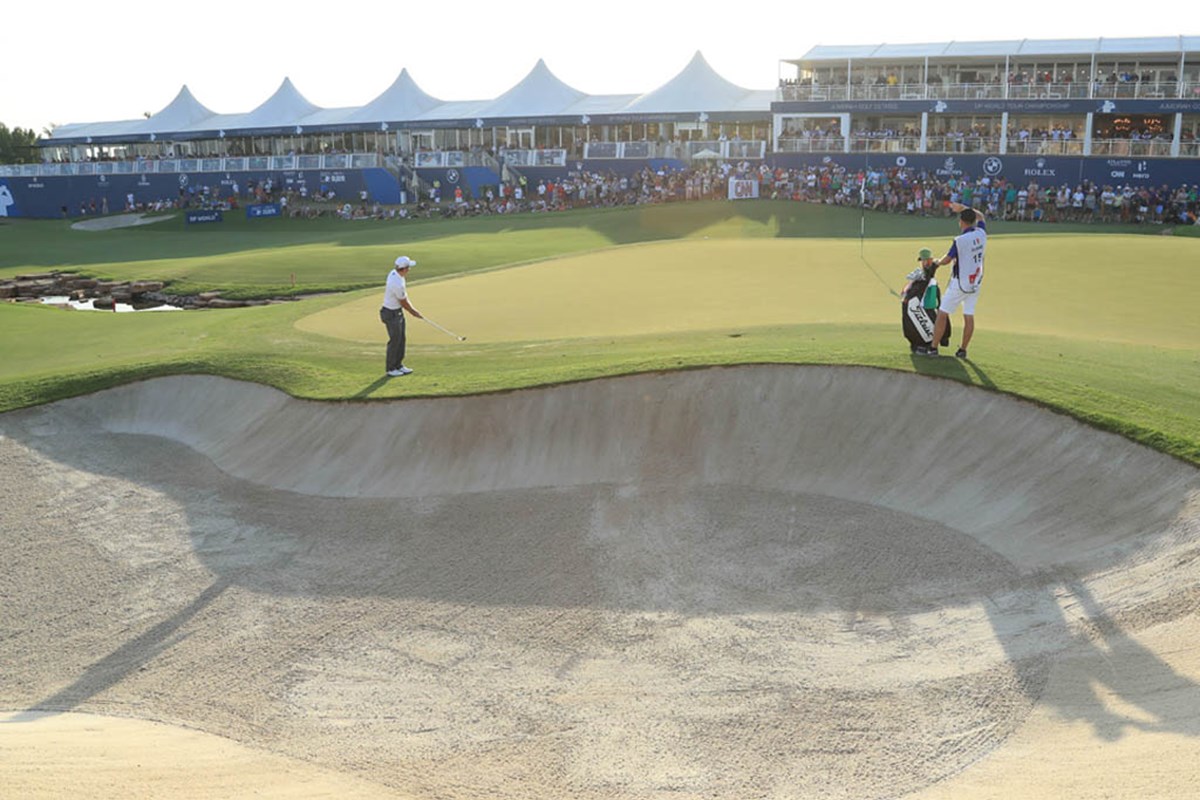Player hitting shot on the 18th Green at the DP World Tour Championship, with hospitality