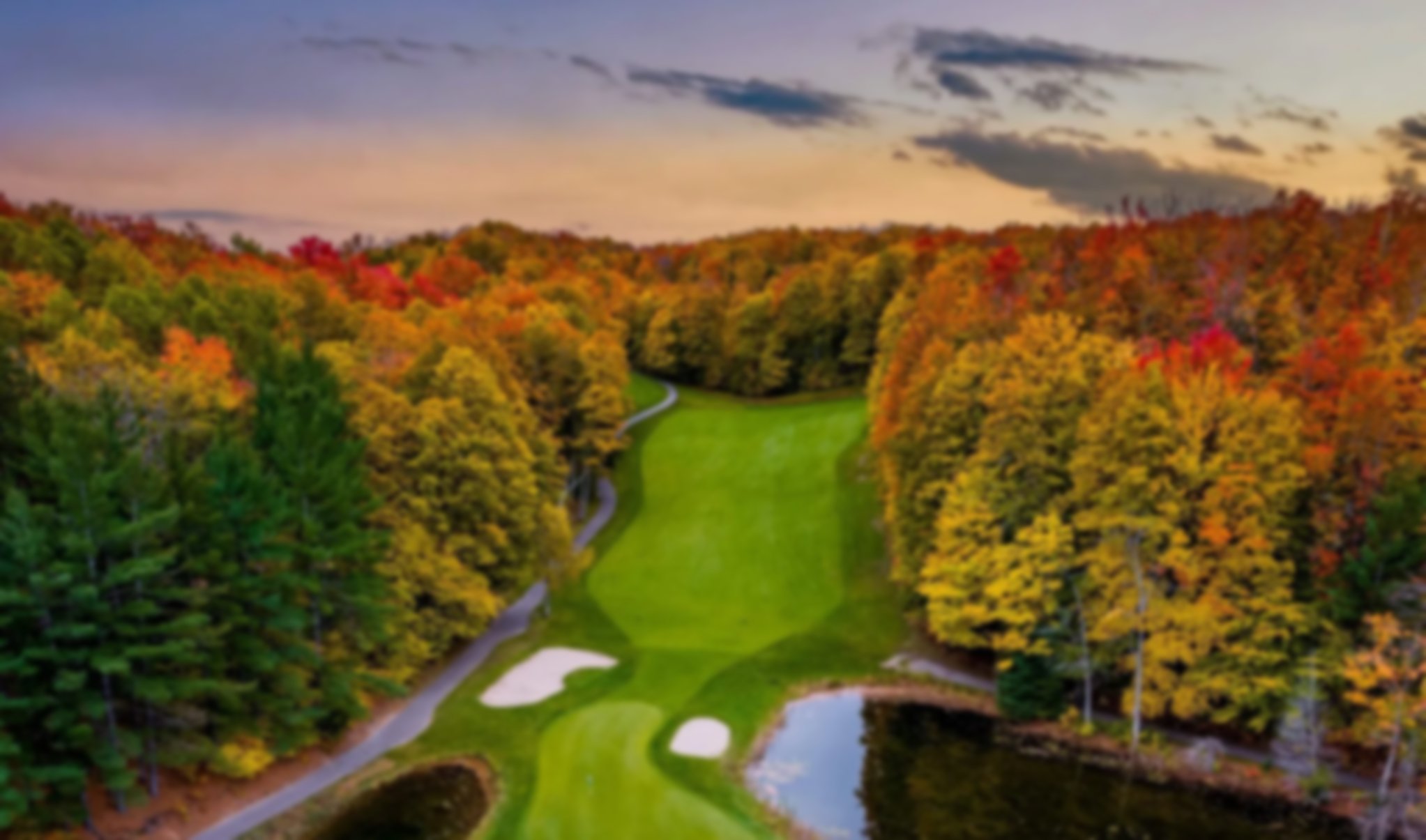 Green with bunkers and autumn trees at Jones' Masterpiece course.