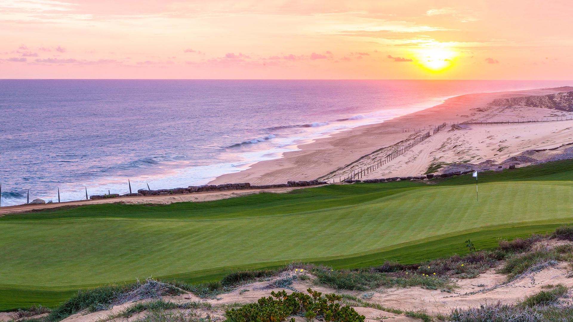 Stunning pink sunset overlooks the long green at Cabo del Sol