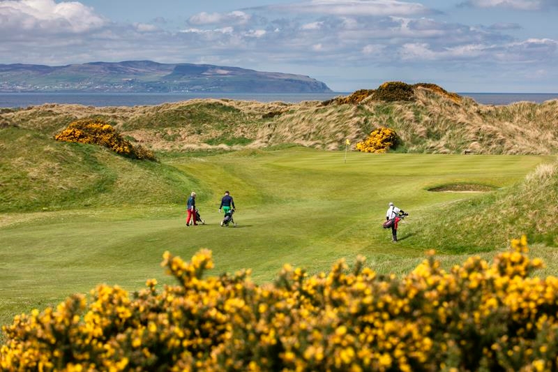 3 Golfers walking on the fairway at Castlerock Golf Club, Northern Ireland