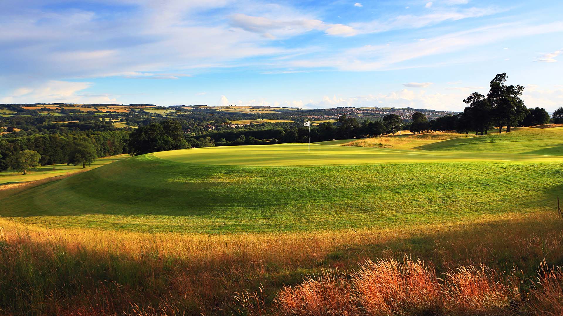 Beautiful blue skies over a raised green