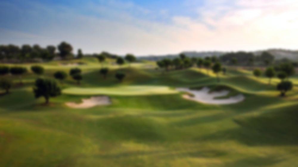 Blissful blue skies over wide greens and large bunkers