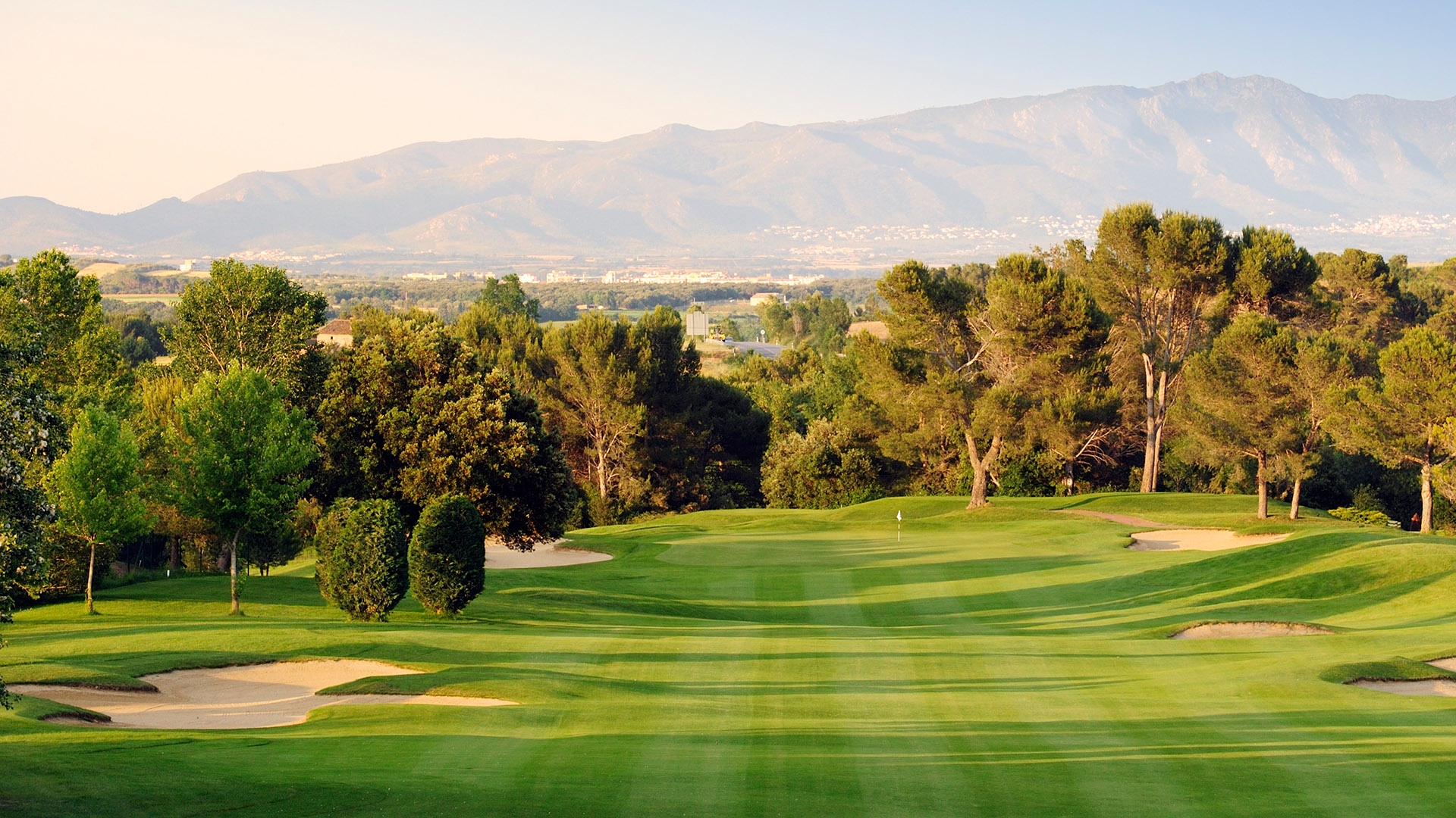 Torremirona's undulating fairways with mountains in the background