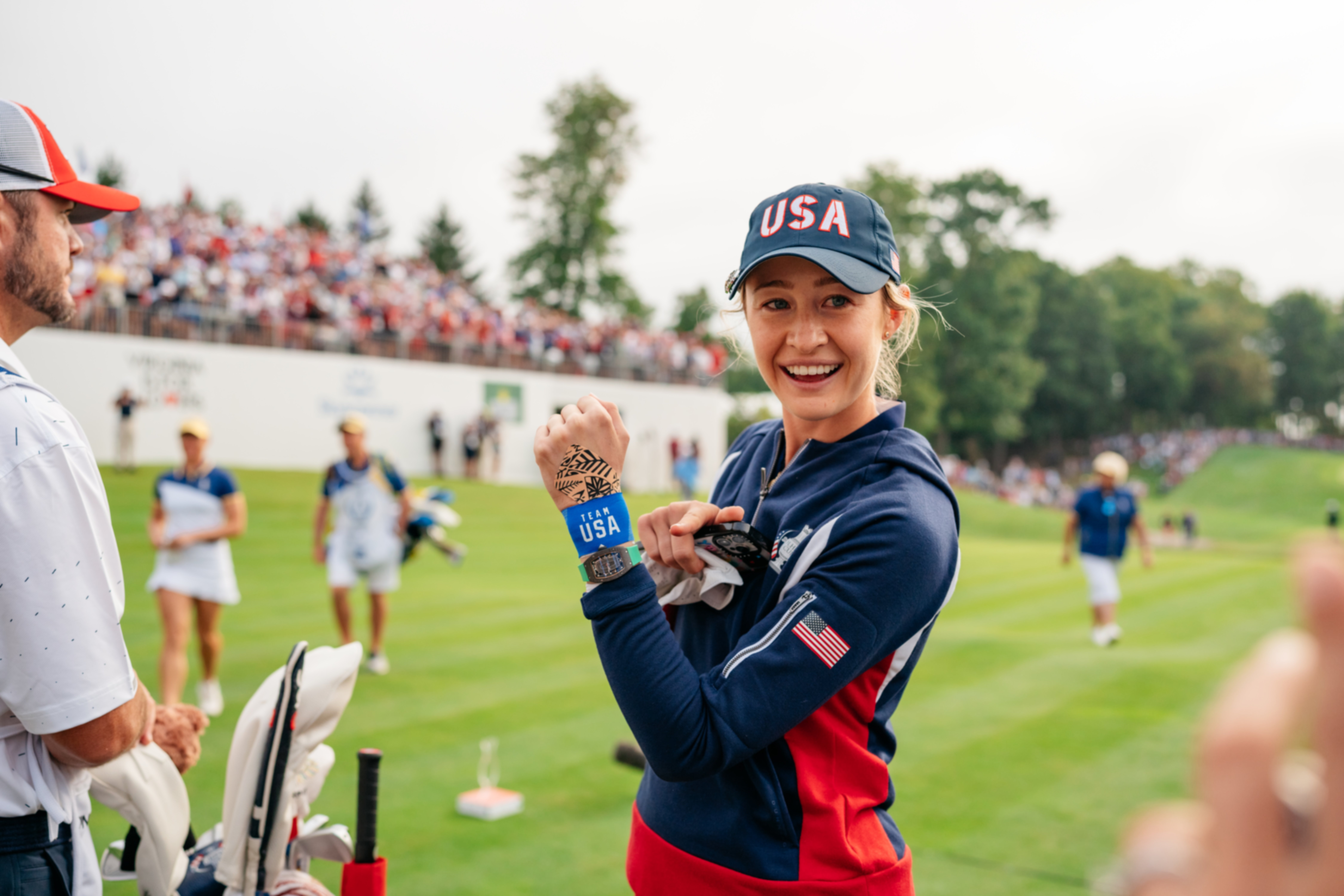 Nelly Korda smiling on the tee box at the Solheim Cup in her USA kit