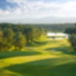 Tree-lined undulating fairways and the expansive lake at the PGA Catalunya