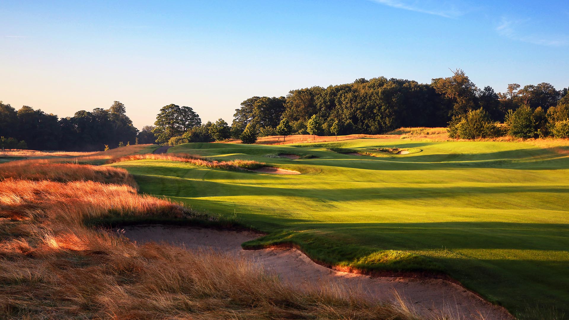 Blue skies over wide fairways