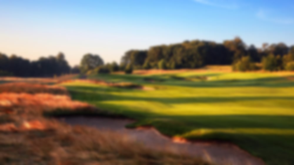 Blue skies over wide fairways