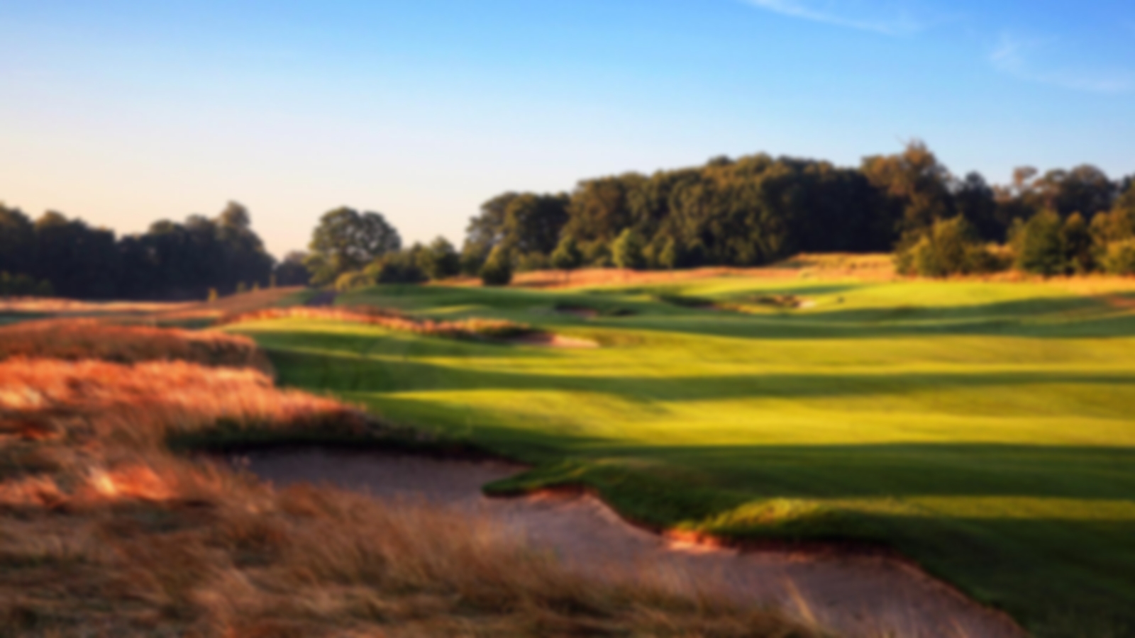 Blue skies over wide fairways