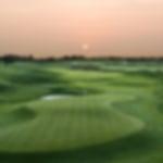 Sunset at Le Golf National L'Albatros page, with beautifully manicured fairways and water fronted green.