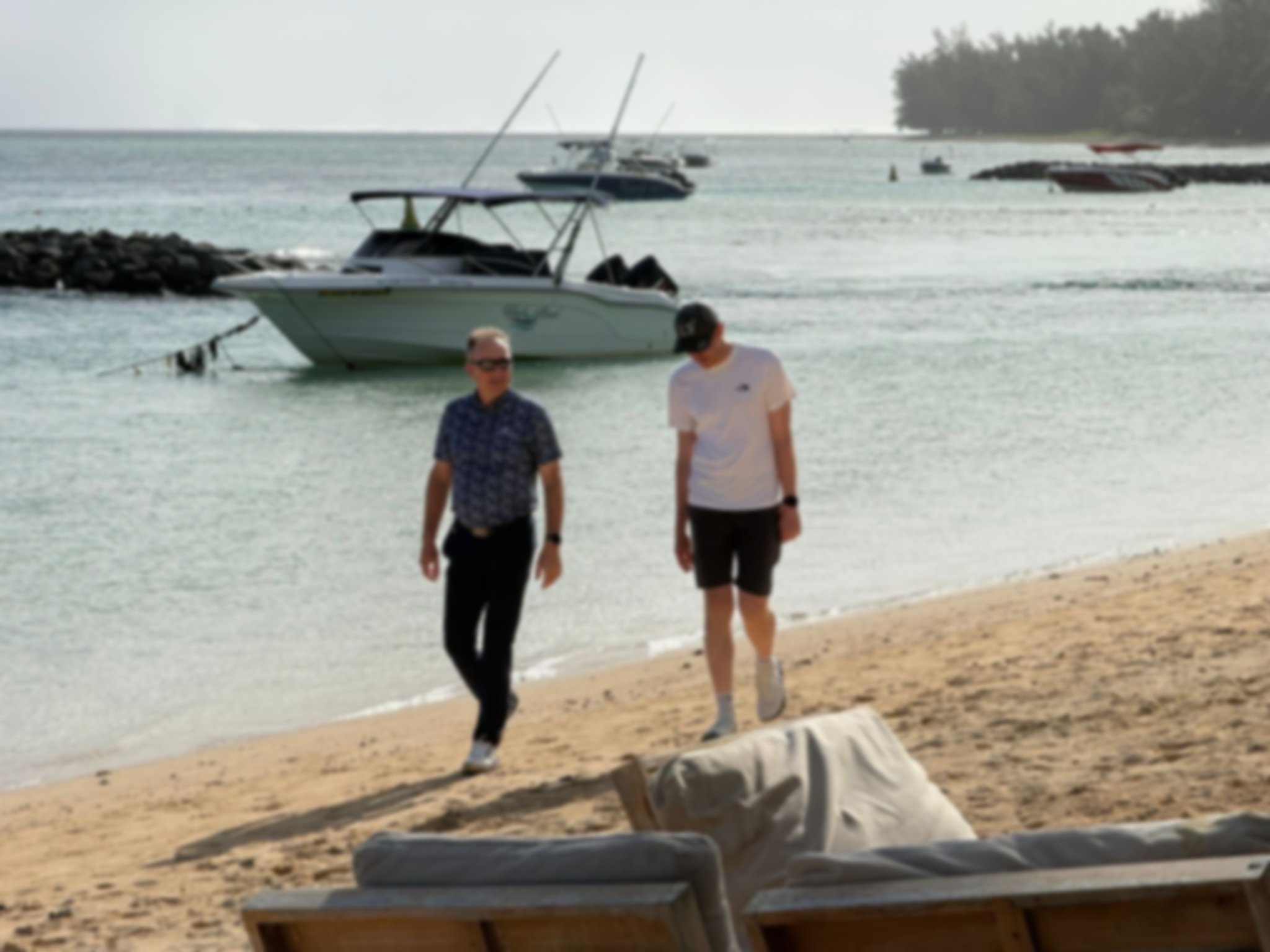 2 men walking on a beach at sunset in Mauritius