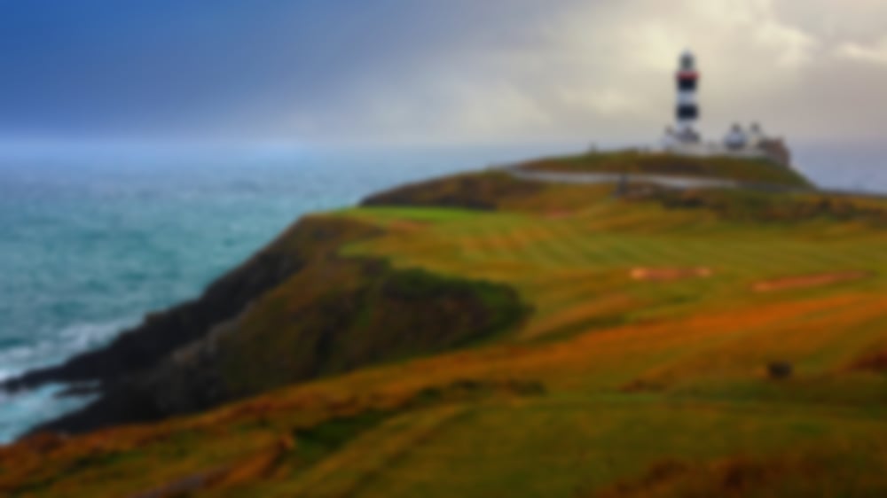 Spectacular ocean side hole at Old Head Links with the lighthouse in the backdrop.
