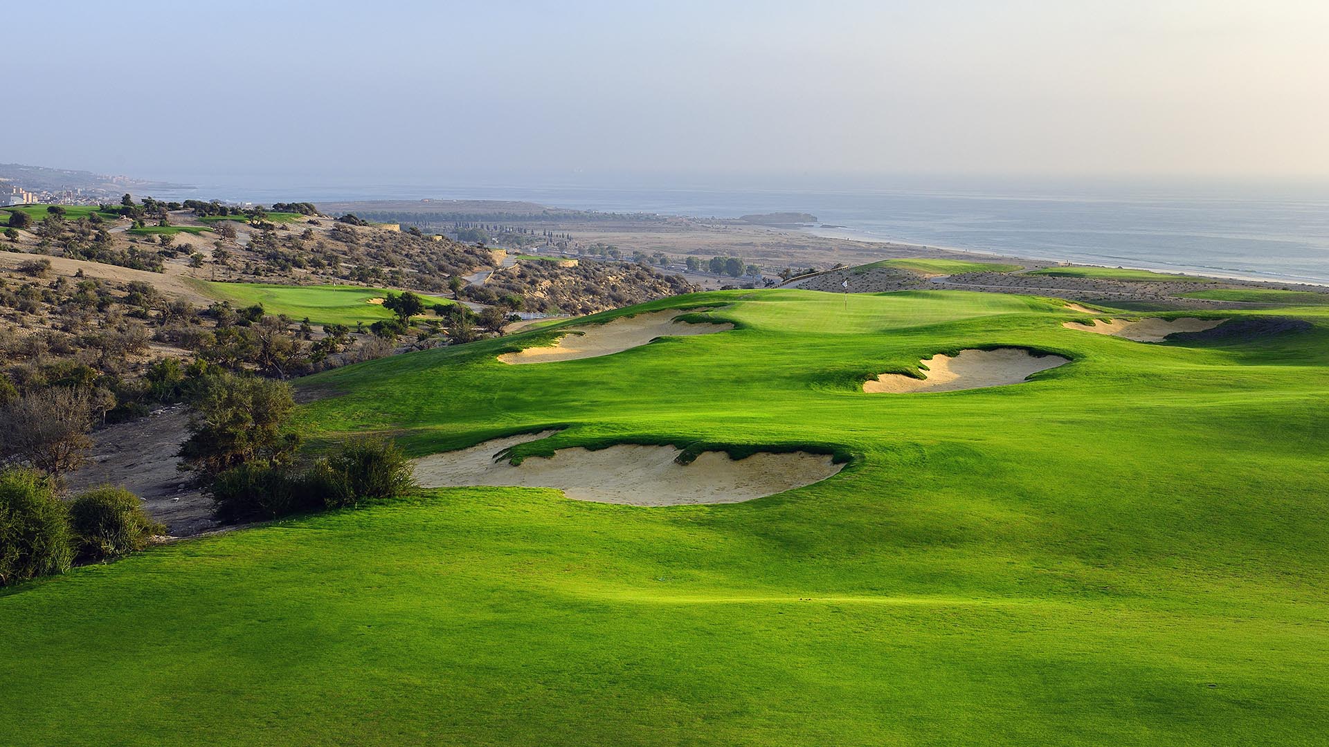 Aerial view of fairway bunkers overlooking the ocean and green at Taghazout.