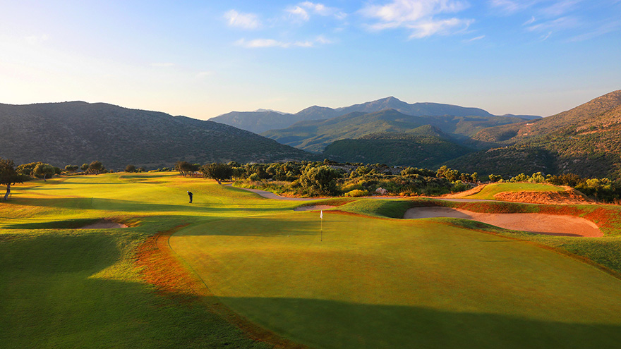 Crete Golf Club green with a beautiful sunset over the backdrop of the surrounding mountains.