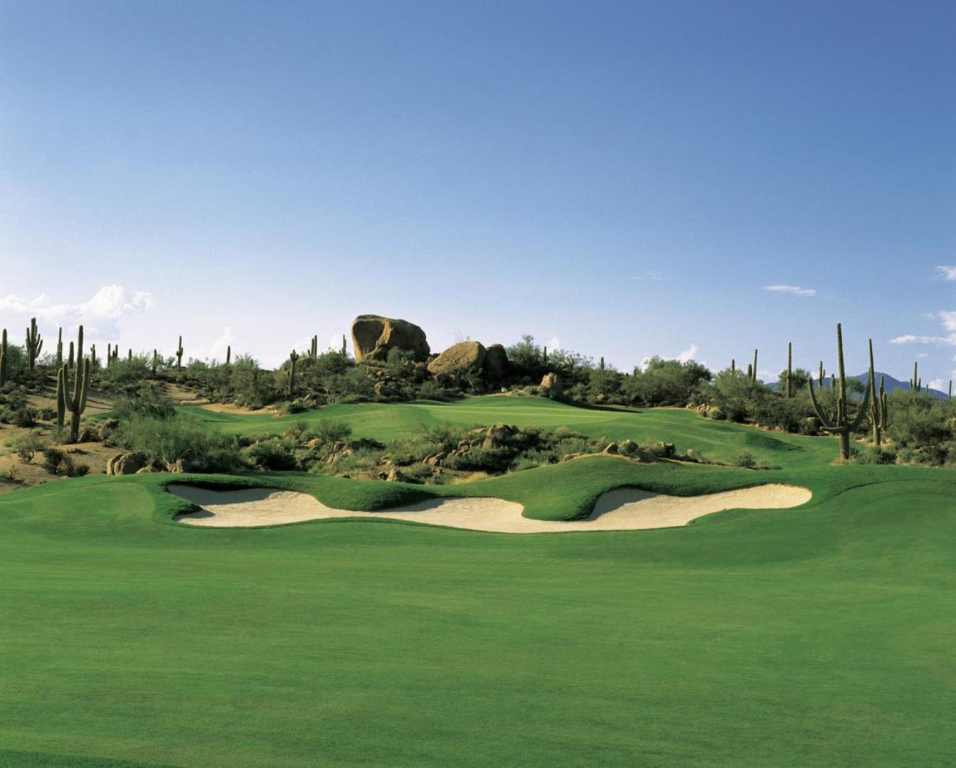 Elevated green with large rock behind the green 