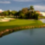 Tight green with bunkers to the left and a water hazard to the right.
