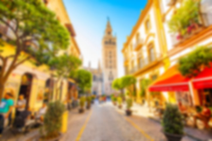 A street in Seville with a church in the background