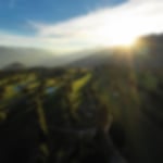 Beautiful swiss mountain with sun coming through the clouds and blue skies