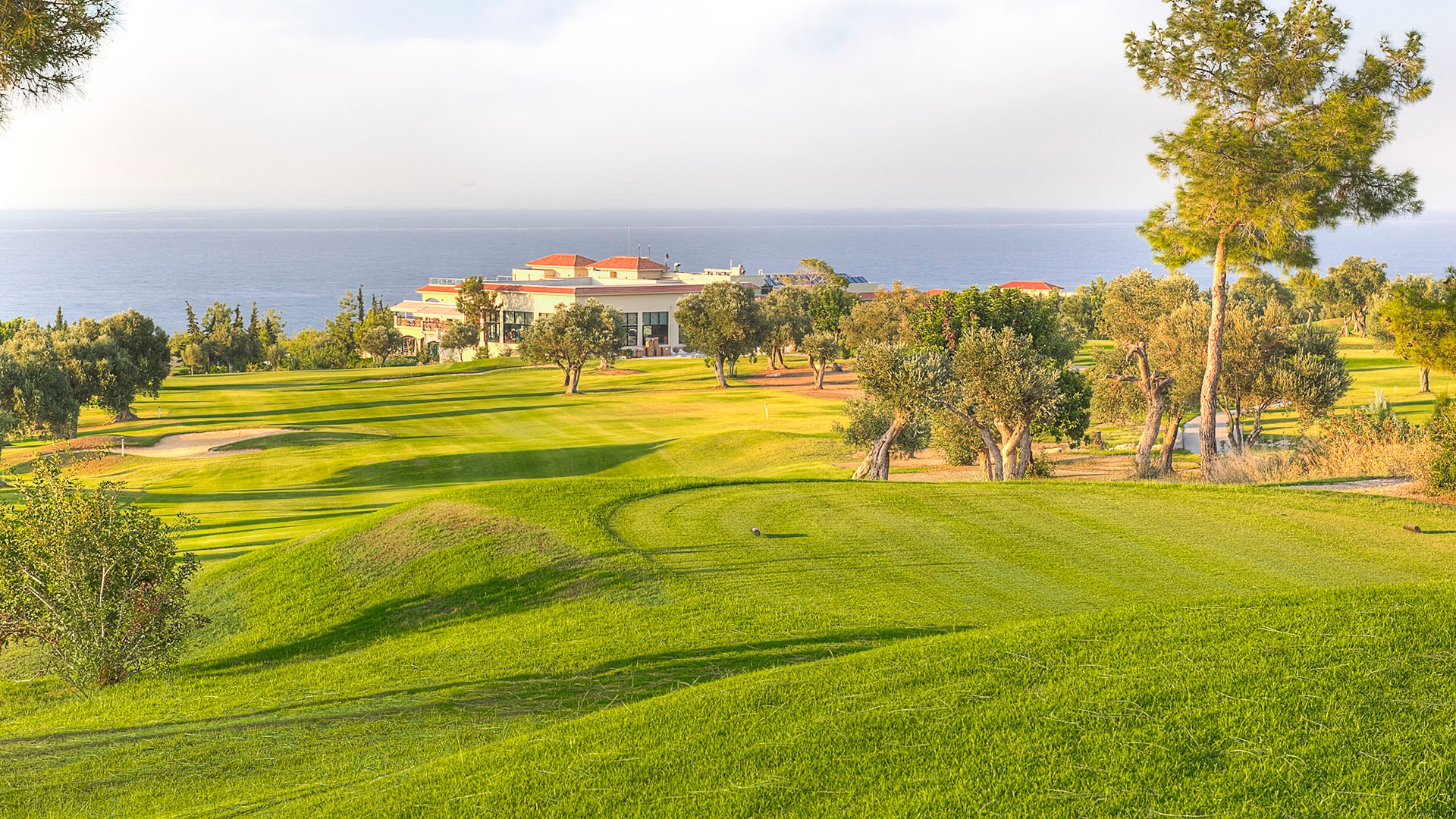 The green fairways with trees on the right at Korrineum