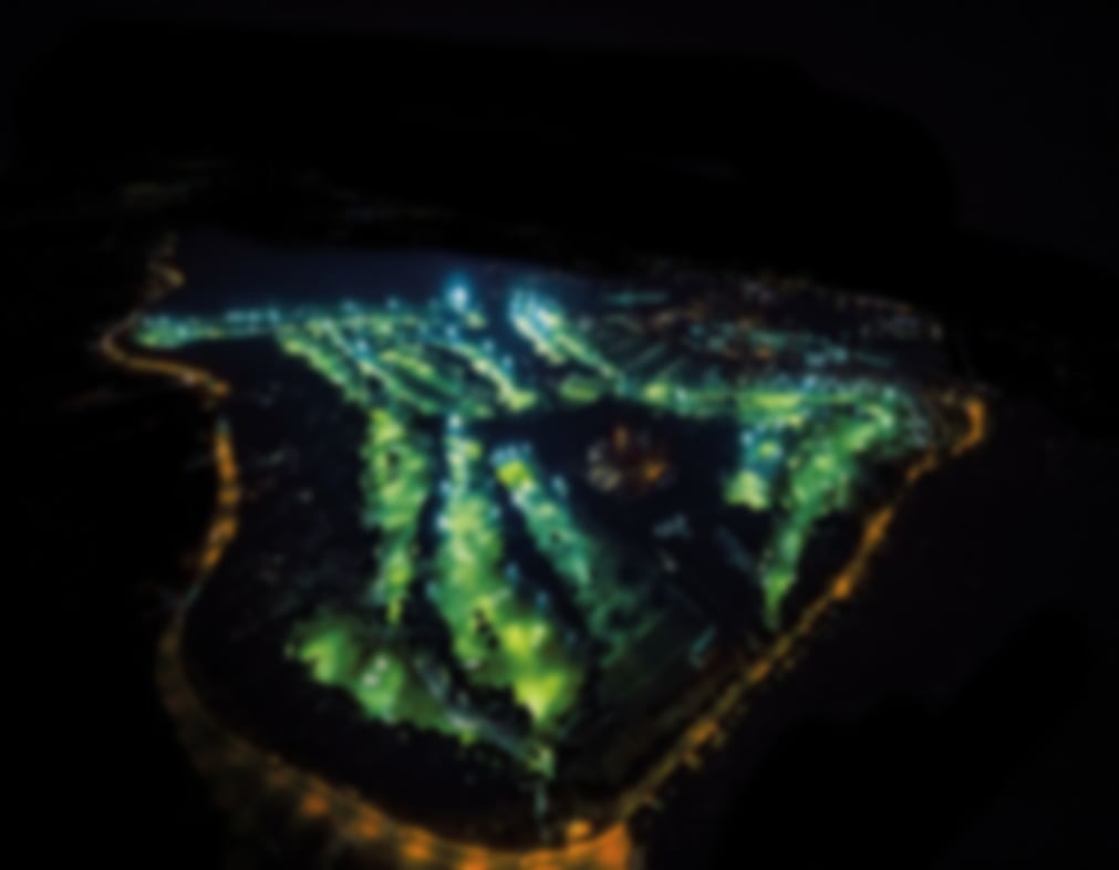 Aerial view of the floodlit Carya Golf Course illuminated for night golf.