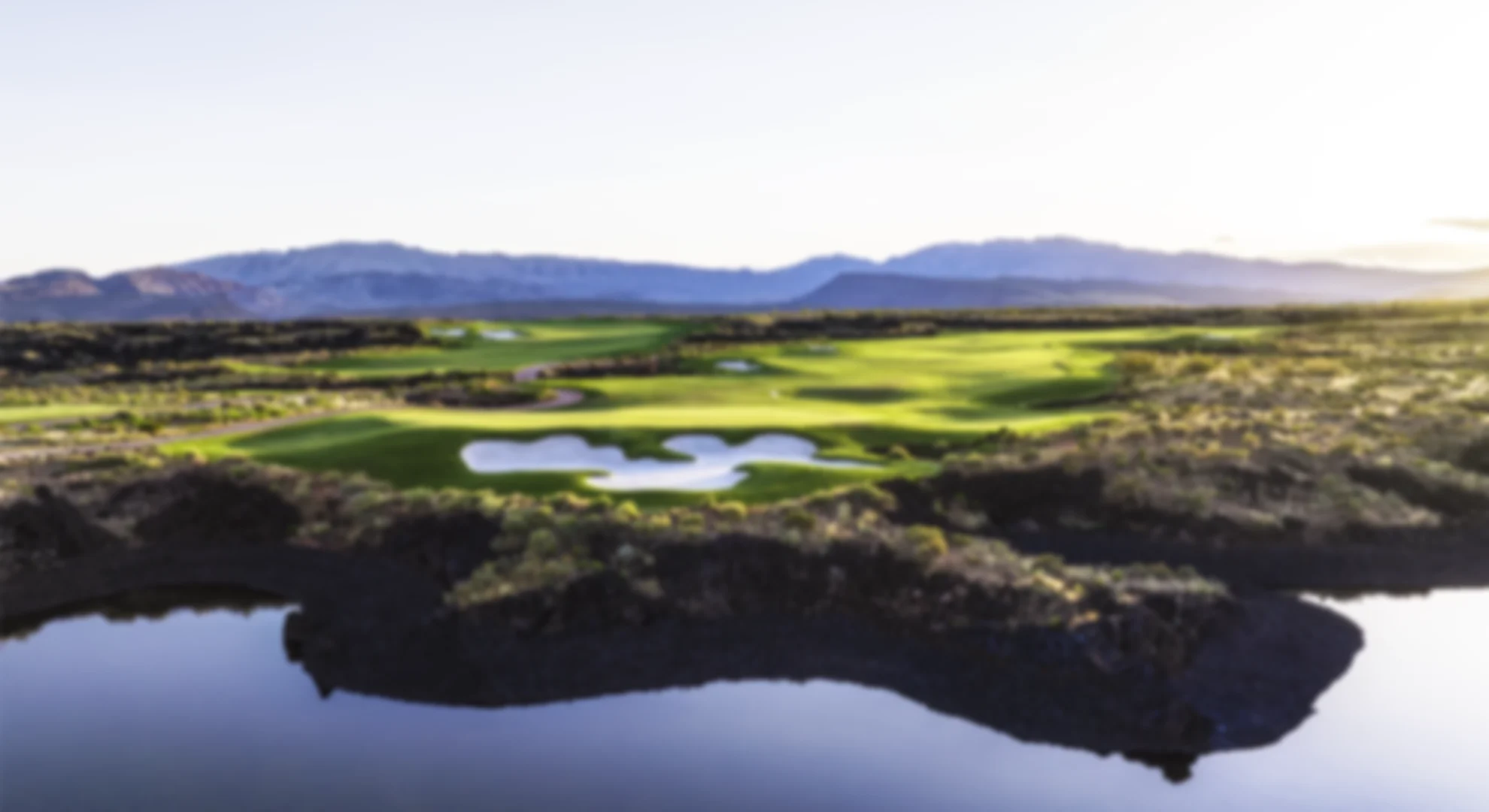 image showing a gof course in a desert setting, there are cliffs in the background