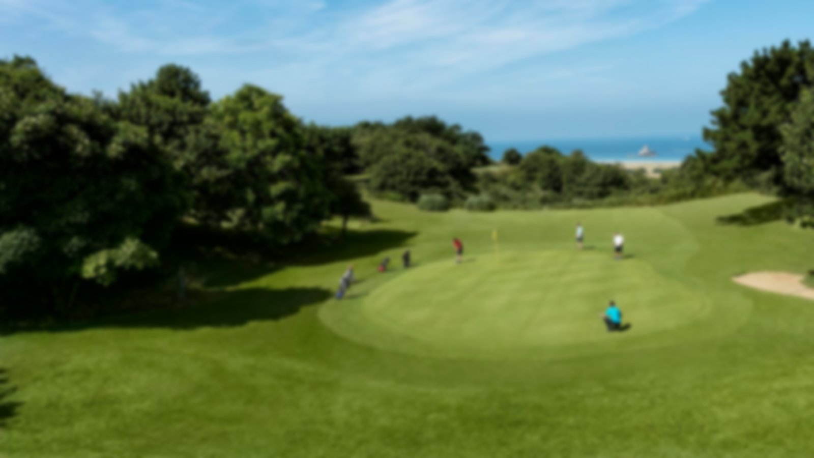Large green played by a four-ball with blue skies