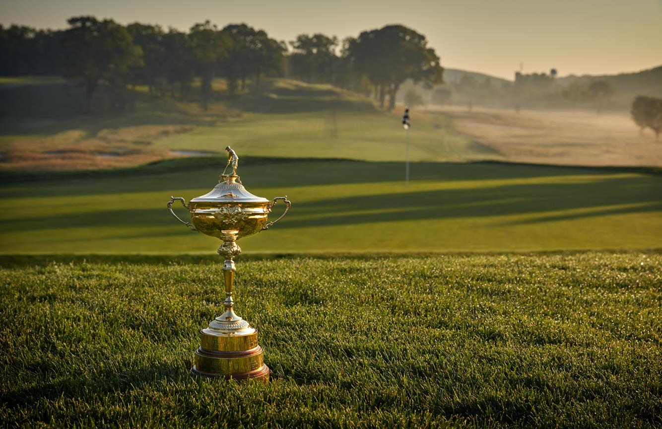 The Ryder Cup trophy sitting in front of a green on the Bethpage Black Golf Course