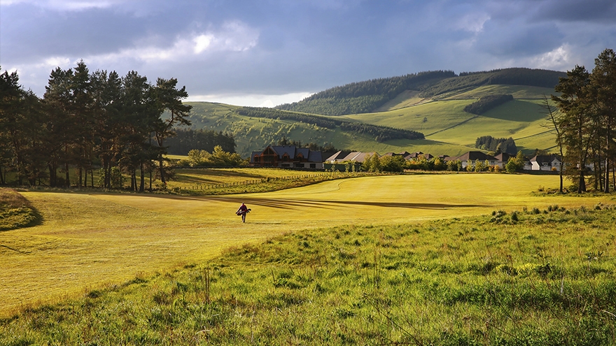 Valley view in the background of stunning golf course.